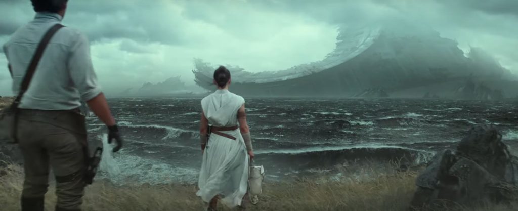 Rey and Poe looking at the wreckage of a Death Star